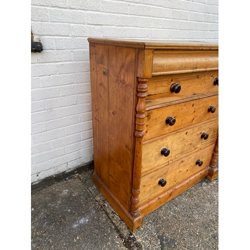 411 - A 19th century pine chest, fitted with ogee drawer over four graduated drawers, all between column s... 