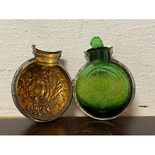 74 - A late Victorian silver cased bottle, the mounts Birmingham 1898, containing green glass bottle and ... 