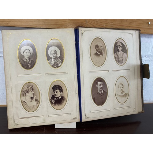 304 - A Victorian photograph album, containing a quantity of carte de visite and photographs, including ni... 