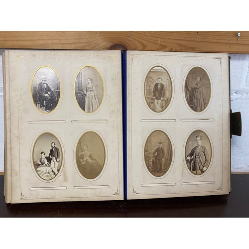 304 - A Victorian photograph album, containing a quantity of carte de visite and photographs, including ni... 