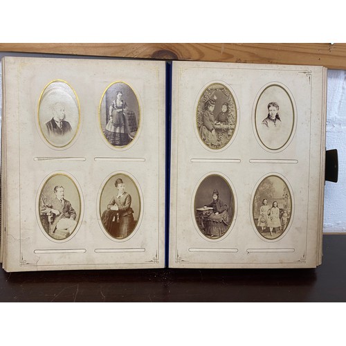 304 - A Victorian photograph album, containing a quantity of carte de visite and photographs, including ni... 