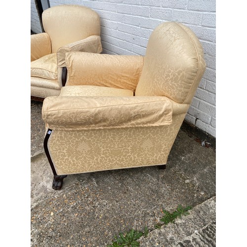 332A - A pair of early 20th century armchairs, with upholstered back, arms and seats, on lion paw legs and ... 