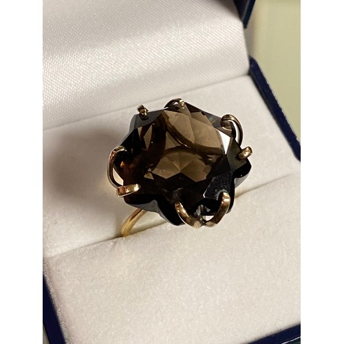 40 - A smoky quartz set dress ring, with fancy cut stone claw set to precious yellow metal mount -