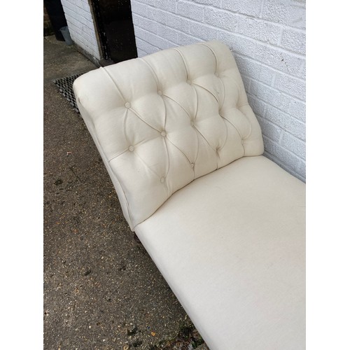 256 - A Victorian chaise longue, with buttoned end, upholstered in cream and on short legs -