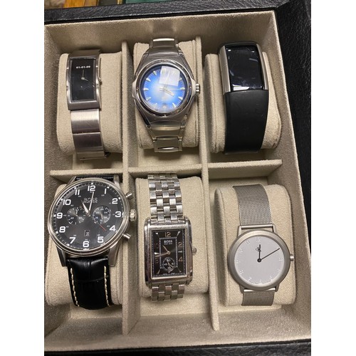 76 - A watch box, with nine wristwatches, including Boss, Fossil and CK -