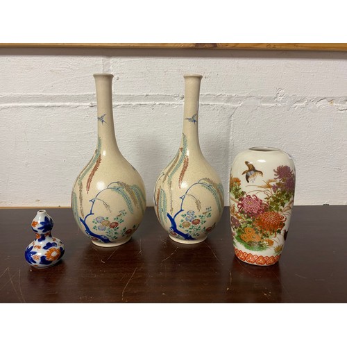 102 - A pair of bottle vases, decorated with trees, a reticulated vase etc -