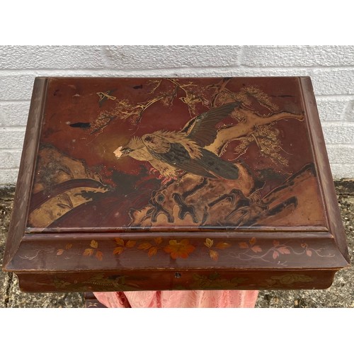 221 - A 19th century lacquered work table, decorated in the Japanese taste, with some contents -