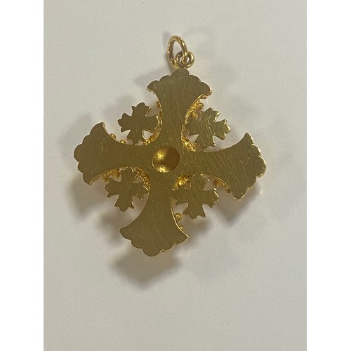 19 - A heavy Middle Eastern yellow metal pendant, of faceted cross design -