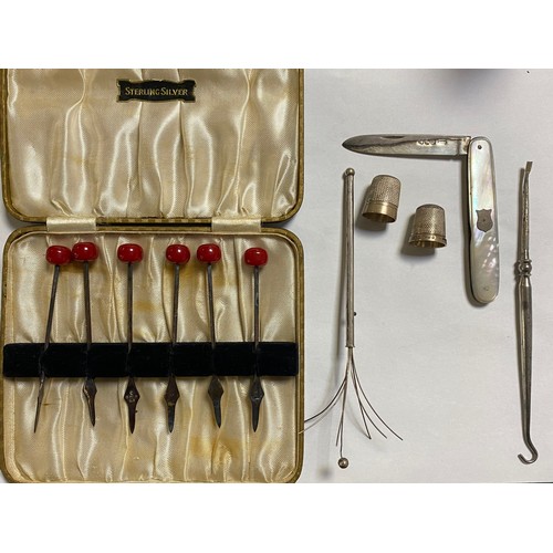 36 - A cased set of six silver mounted picks, London 1934, together with a silver and mother-of-pearl fru... 