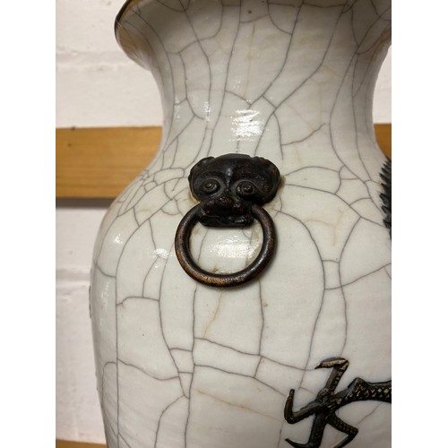 157 - A late 19th/early 20th century Chinese crackleware vase, moulded with mask and ring handles and a dr... 