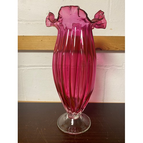 168 - A tall cranberry glass vase, with fluted rim -