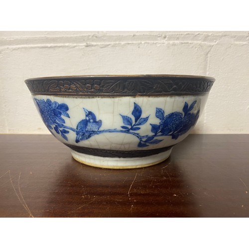 173 - A late 19th/early 20th century Chinese crackleware bowl, the interior decorated with a panel of flow... 