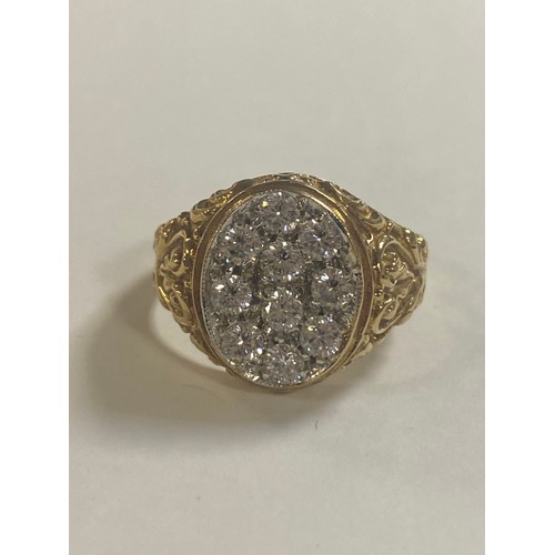 55 - A 9ct gold and CZ ring, set with an oval panel of CZ within textured shoulders -