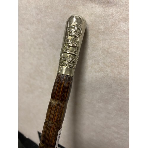 477 - A swagger stick, the handle with regimental crest -