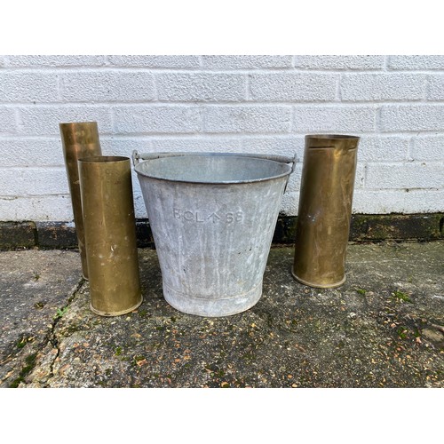 479 - Militaria: three shell cases and an army issue bucket (4) -