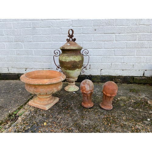 480 - A terracotta urn, an amphora style urn and cover and a pair of ball finials -