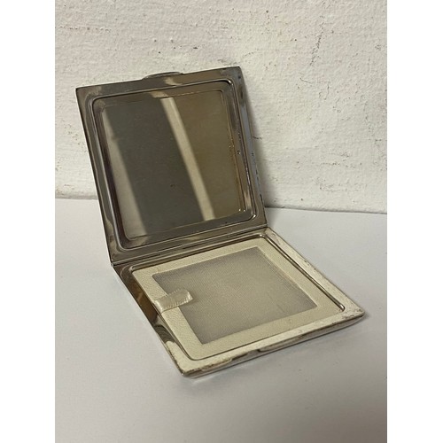 77 - An Art Deco silver compact, with geometric engraved decoration -