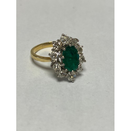 124 - An emerald and diamond dress ring, set with an oval emerald within a border of ten diamonds, to 18ct... 