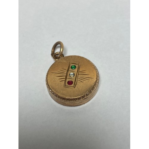 126 - An early 20th century pendant/locket, set with a traffic light design, in yellow metal mount (back d... 