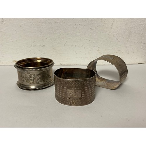 12 - A pair of silver napkin rings, Birmingham 1943, together with an 800 standard German napkin ring -