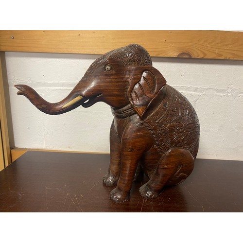 227 - A heavily carved hardwood elephant -