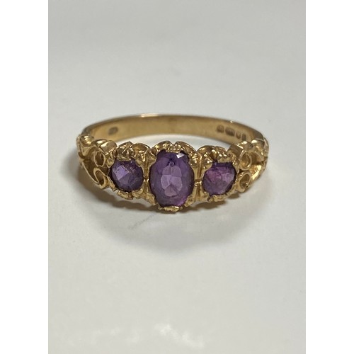 25 - A 9ct gold ring, set with three amethysts -