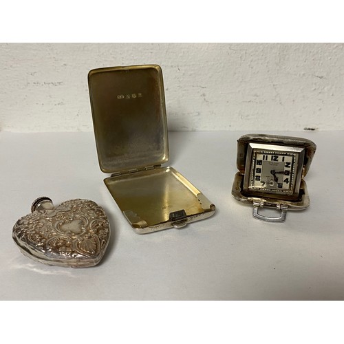 40 - A group of three collectable silver items, comprising silver match cover, silver scent flask and sil... 