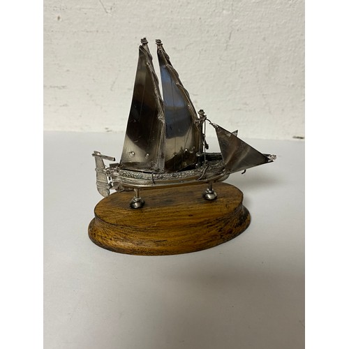 41 - A miniature white metal model ship on wooden base -