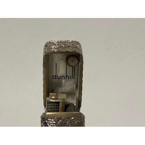 47 - Dunhill: a 'Rollagas' cigarette lighter, in woven textured white metal case, stamped 750 to base and... 