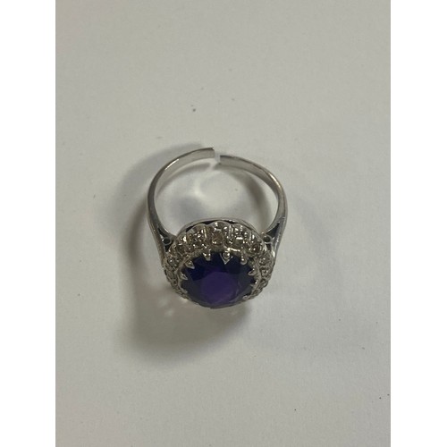 53 - An amethyst and diamond set dress ring, of oval cluster design, in precious metal mount (shank cut) ... 