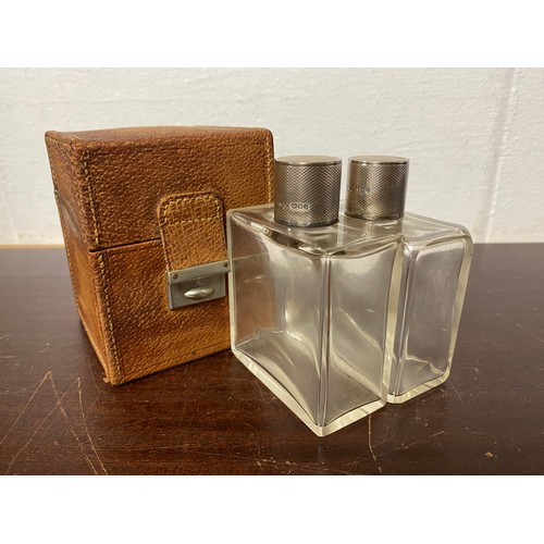 59 - A cased pair of Edwardian silver mounted toilet bottles, London 1906, in fitted case by Finnigans Lo... 