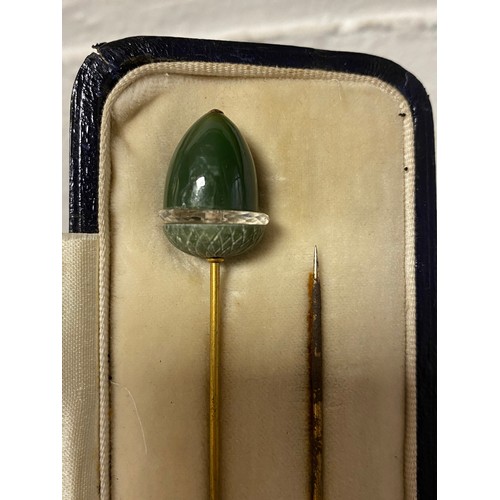 60 - A cased pair of antique hat pins, each terminal of acorn design -