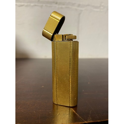 64 - Cartier: a gold plated lighter -