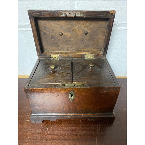 97 - An 18th century oak tea caddy, with brass handle and two lidded compartments -