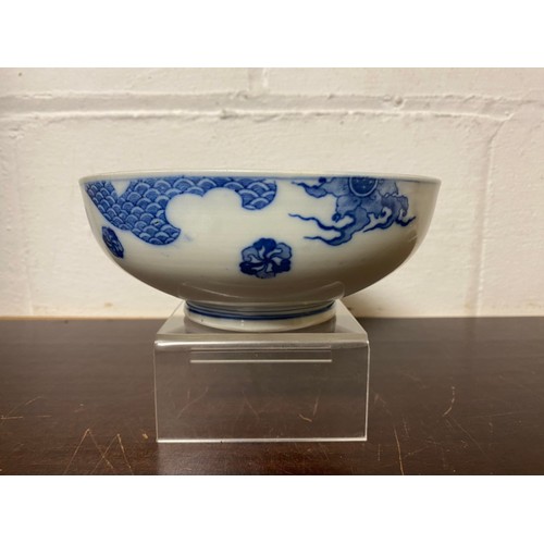 129 - A Chinese blue and white bowl, painted with a landscape panel with figure on a bridge -