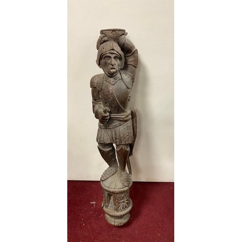 100 - A carved oak figural mount, carved to depict a Knight in armour -