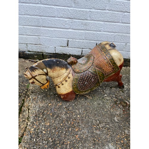 412 - A group of three 'folk art' carousel type carved and painted horses, each with typical decoration -