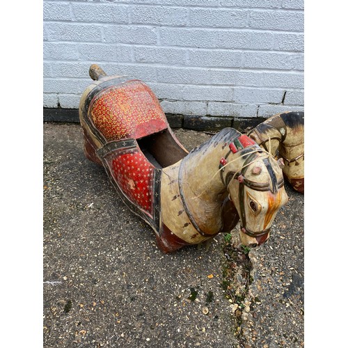 412 - A group of three 'folk art' carousel type carved and painted horses, each with typical decoration -