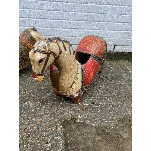 412 - A group of three 'folk art' carousel type carved and painted horses, each with typical decoration -