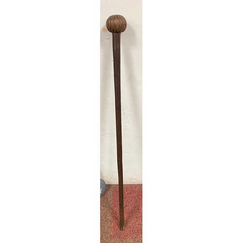 419 - A tribal club, with carved handle -