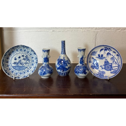 135 - A pair of blue and white Chinese vases, each with moulded sides and painted with flowers, together w... 