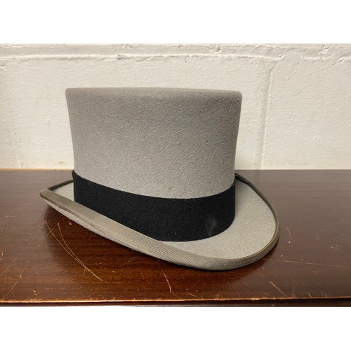 261 - A grey top hat by Moss Bros -