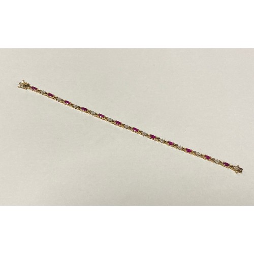 13 - A ruby and diamond line bracelet, composed of oval rubies and diamond clusters, all set in 9ct gold ... 