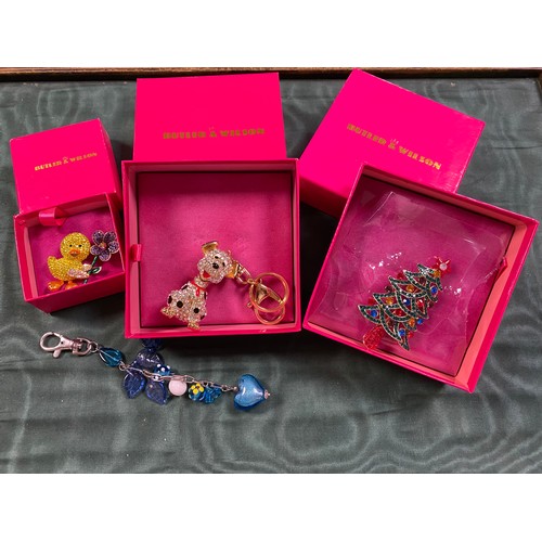 14 - A Butler & Wilson dalmation bag charm, two Butler & Wilson brooches and a Murano glass charm -