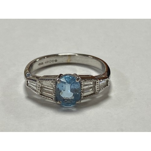 19 - An aquamarine and diamond ring, the oval aquamarine between diamond set shoulders, set with 18ct whi... 