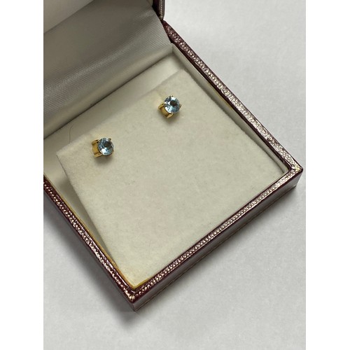 20 - A pair of aquamarine ear-studs, set in 18ct yellow gold -