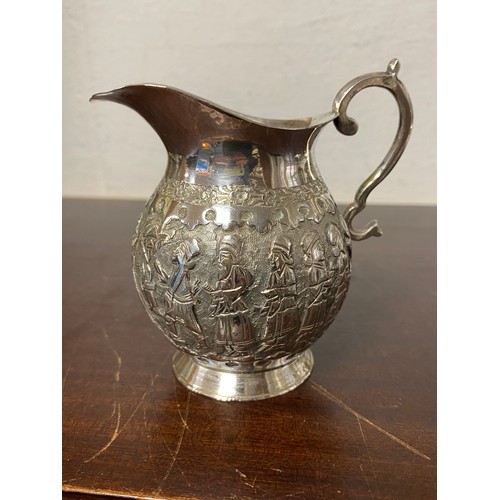 51 - A white metal jug, foreign control marks, decorated with a continuous band of figures -