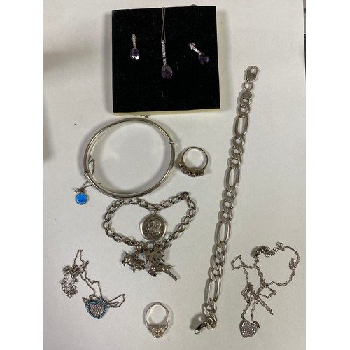 59 - A silver charm bracelet, silver bangle and other silver jewellery -