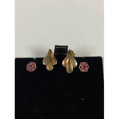 61 - A pair of ruby set flowerhead earrings, together with another pair of 9ct gold earrings -