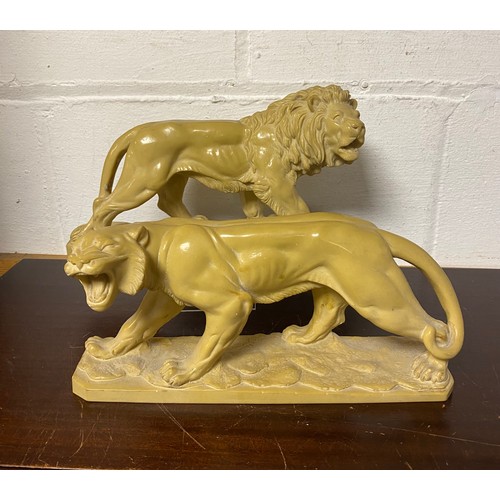 129 - A pair of 19th century style moulded lions, impressed Rugeri -